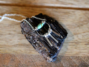 Necklace with a pendant on a dark stone surface